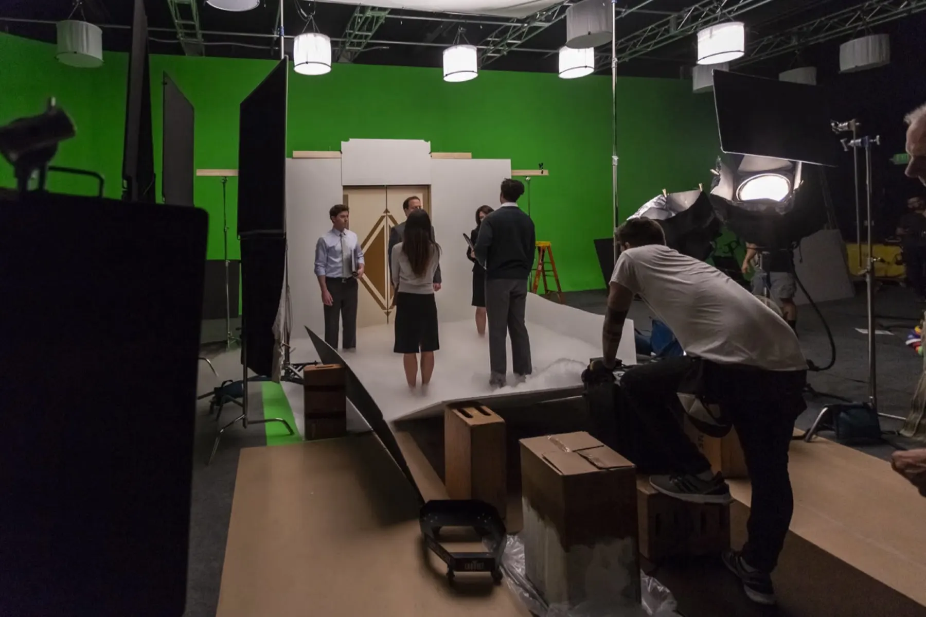 CBIZ greenscreen, actors on the elevator set with green behind
