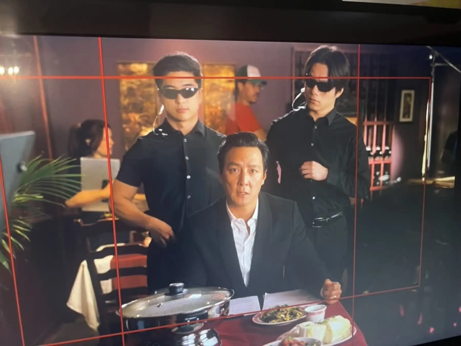 Daniel Wu on set in restaurant scene
